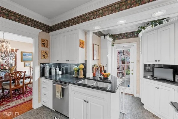 a kitchen with stainless steel appliances a sink and a refrigerator