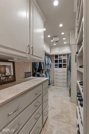 a kitchen with stainless steel appliances kitchen island granite countertop a refrigerator and a sink