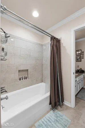a bathroom with a tub a sink and a shower