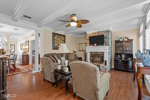 a living room with furniture a fireplace and a flat screen tv