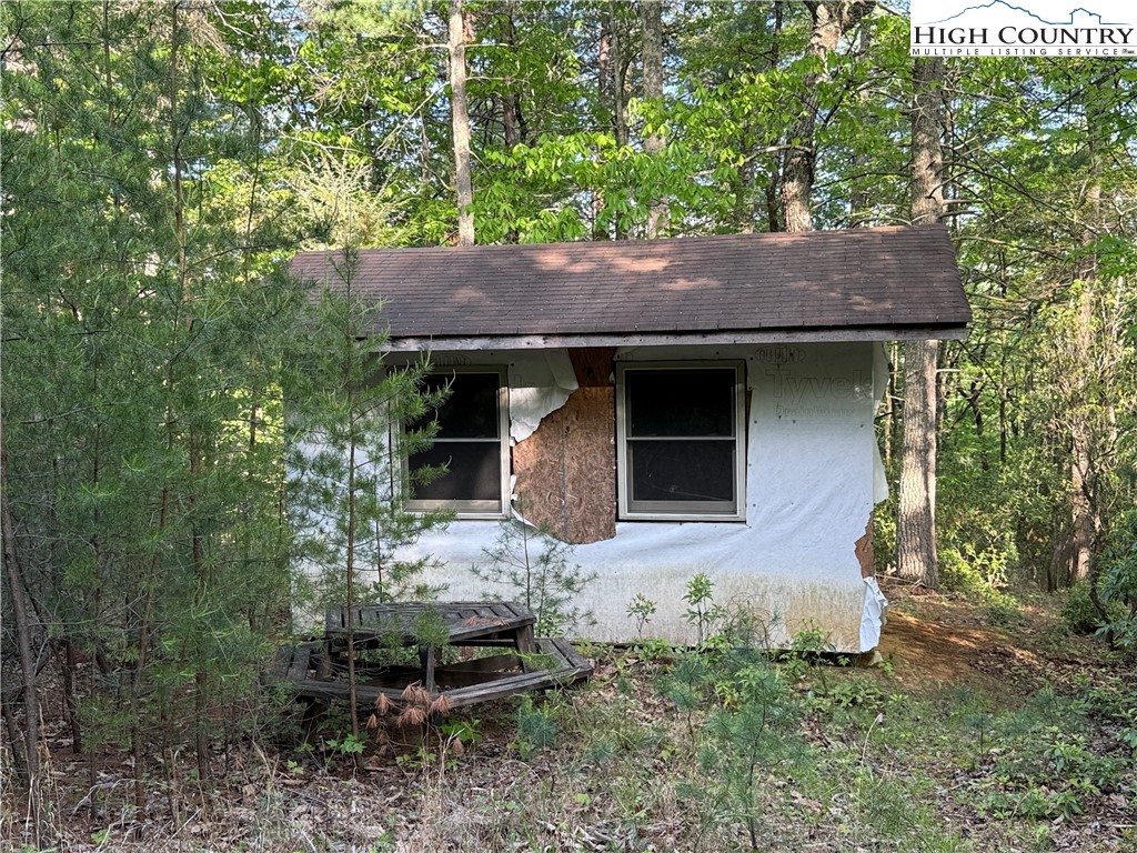 Lot 27 Wolf Pen Road Purlear, NC 28665 - Photo 12 of 48 a front view of a house with garden