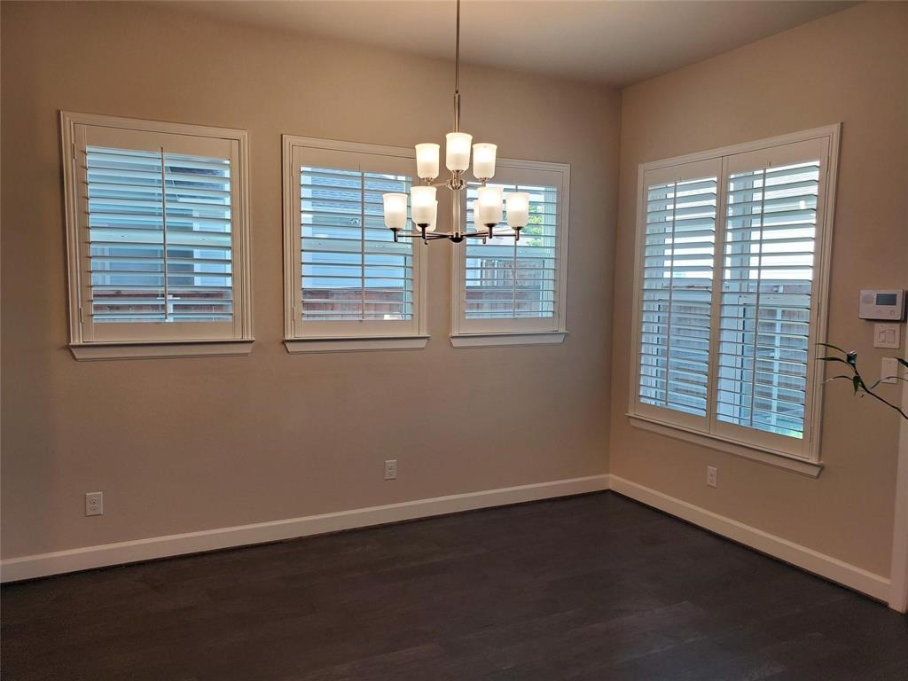 2846 Lotus Street Carrollton, TX 75007 - Photo 16 of 21 an empty room with wooden floor and windows