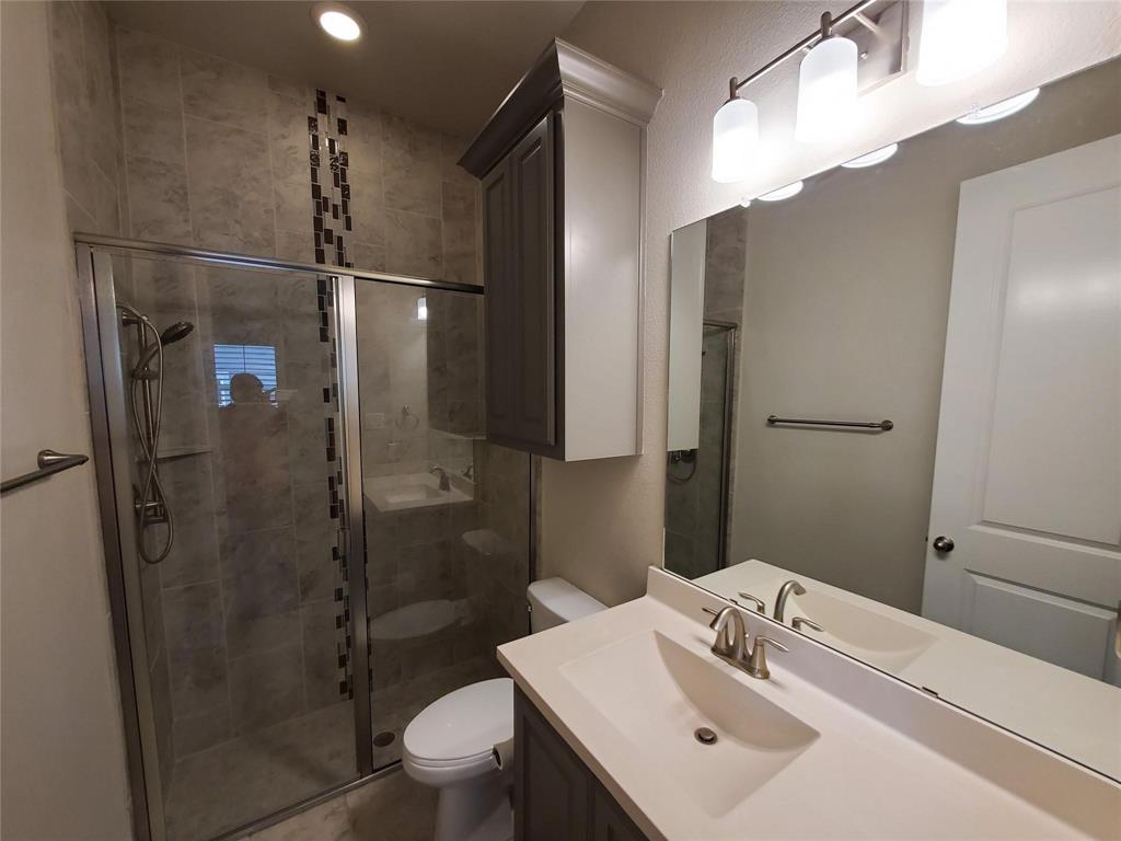 2846 Lotus Street Carrollton, TX 75007 - Photo 5 of 21 a bathroom with a sink toilet and shower