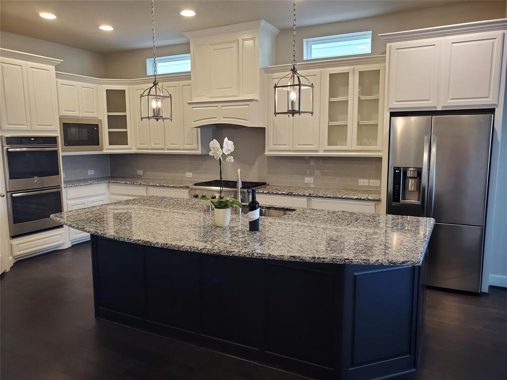 2846 Lotus Street Carrollton, TX 75007 - Photo 7 of 21 a kitchen with kitchen island granite countertop a sink appliances and cabinets