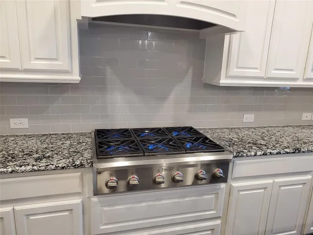 a stove top oven sitting inside of a kitchen