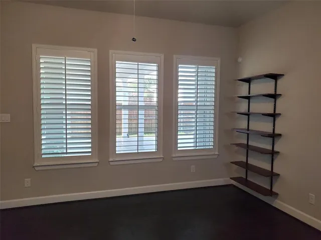an empty room with windows and closet
