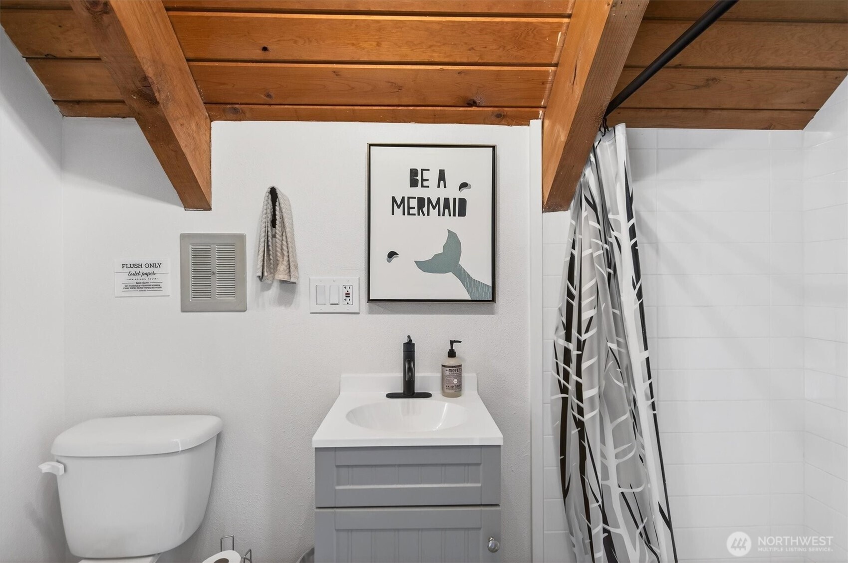 301 West Sunny Sands Road Cathlamet, WA 98612 - Photo 17 of 39 a bathroom with a toilet and a shower curtain