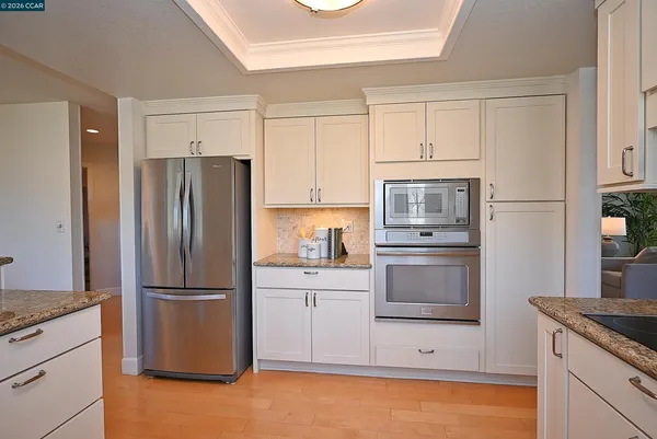 a kitchen with stainless steel appliances granite countertop a stove a sink a table and chairs