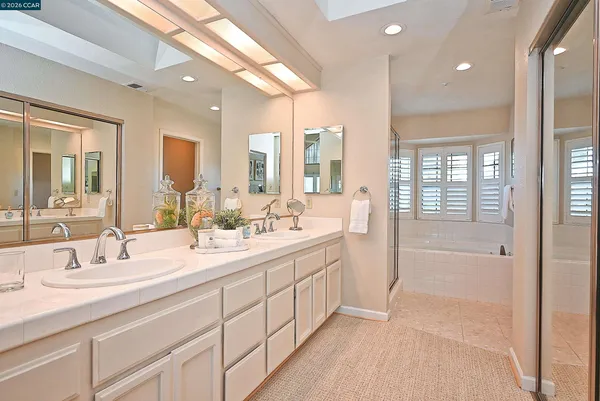 a en suite spacious bathroom with a tub and shower
