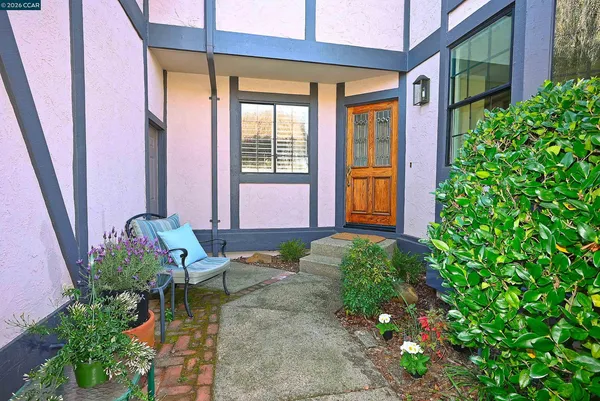 a front view of a house with outdoor seating and plants