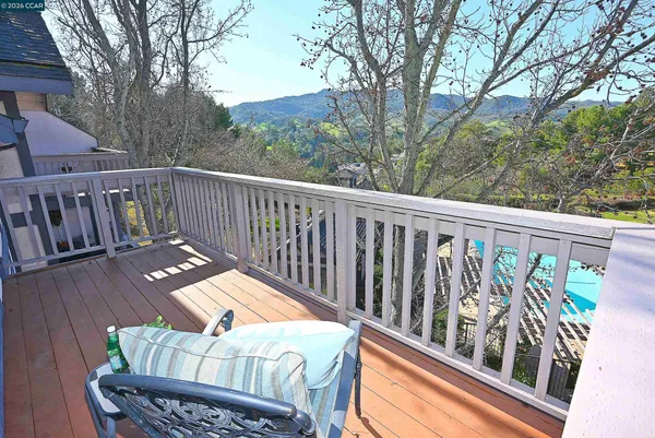 a balcony with wooden floor and outdoor space