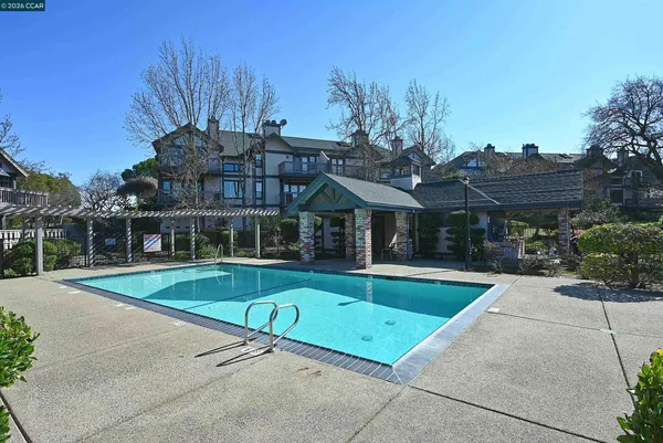 a view of a house with backyard porch and sitting area