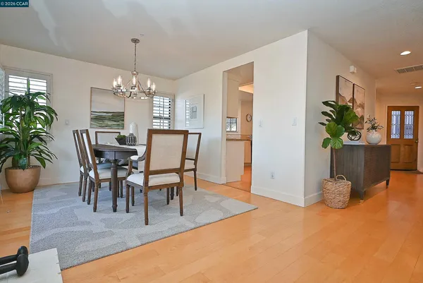 a living room with furniture and a dining table