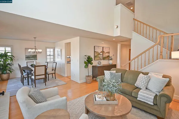 a living room with furniture a fireplace and a potted plant