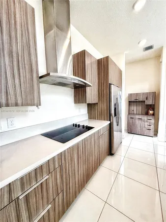 a kitchen with stainless steel appliances a stove and a refrigerator