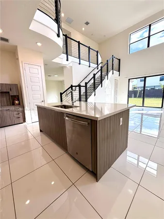a kitchen with stainless steel appliances granite countertop a sink and a stove