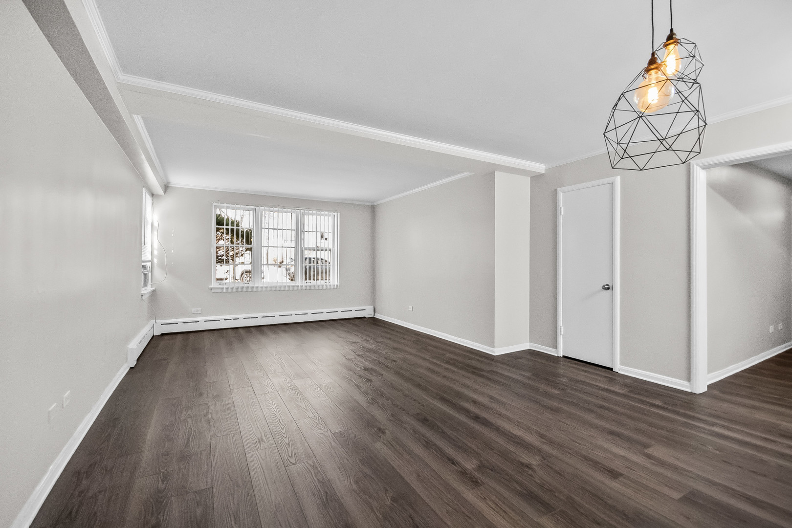 2230 Central Street, Unit G Evanston, IL 60201 - Photo 2 of 11 a view of an empty room with wooden floor and a window