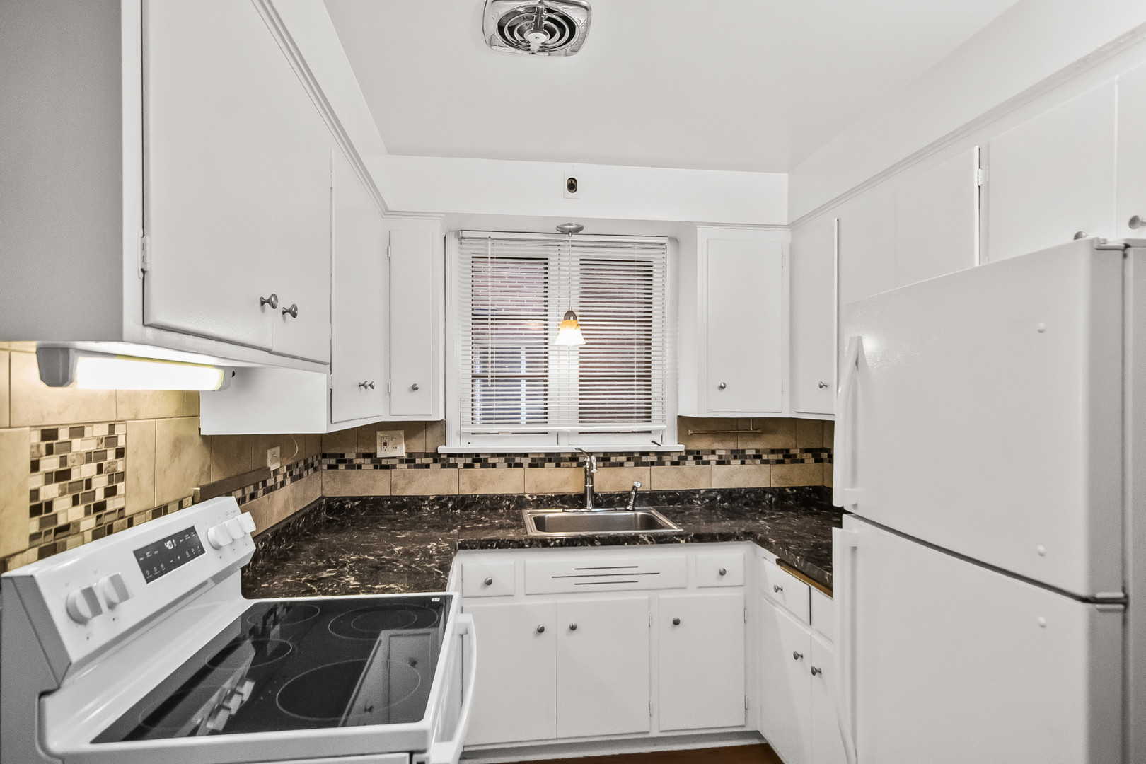 2230 Central Street, Unit G Evanston, IL 60201 - Photo 4 of 11 a kitchen with granite countertop a sink stove and refrigerator