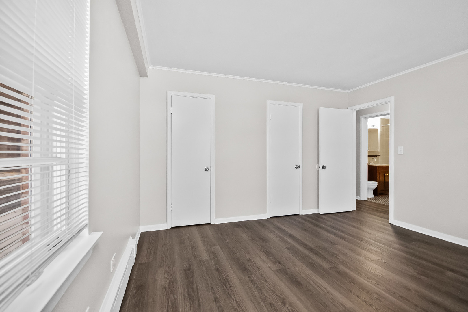 2230 Central Street, Unit G Evanston, IL 60201 - Photo 6 of 11 wooden floor in an empty room with a window