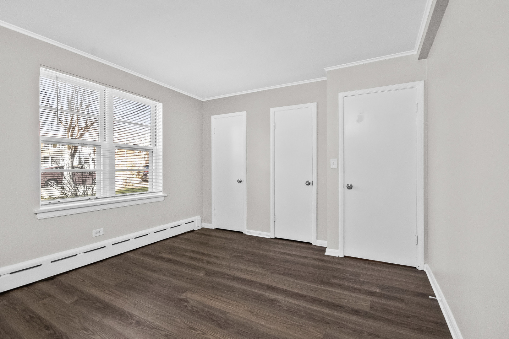 2230 Central Street, Unit G Evanston, IL 60201 - Photo 7 of 11 a view of an empty room with wooden floor and a window