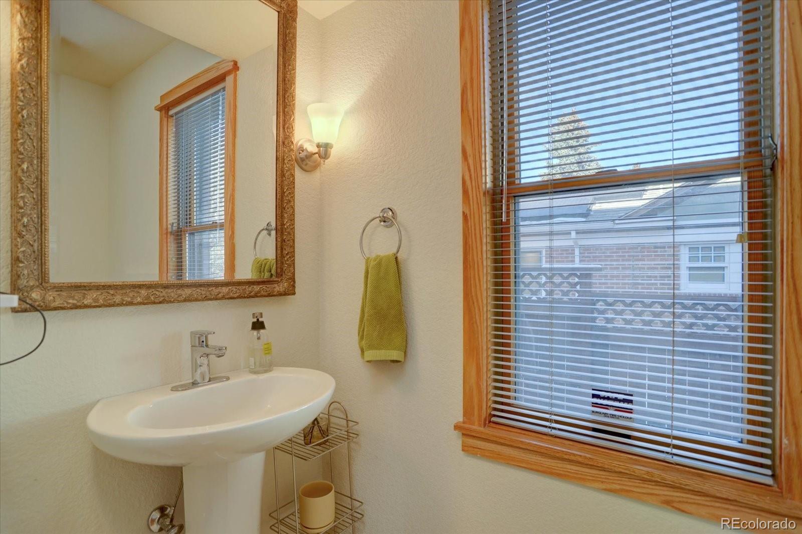 815 16th Street Boulder, CO 80302 - Photo 14 of 47 a bathroom with a sink and a mirror