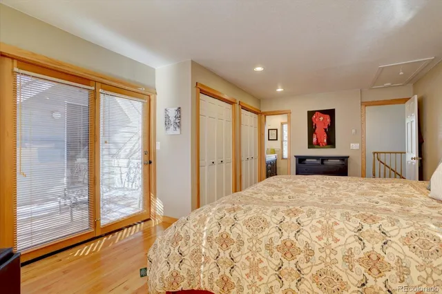a bedroom with a large bed and a large window