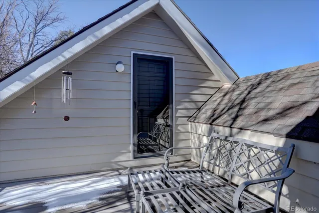 a view of backyard with wooden fence and large trees
