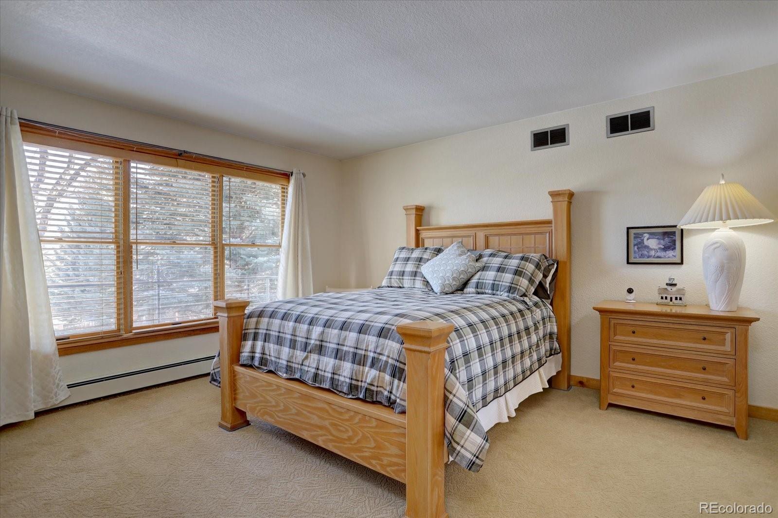 815 16th Street Boulder, CO 80302 - Photo 25 of 47 a bedroom with a bed and a night stand