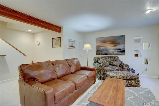 a living room with furniture and painting on the wall