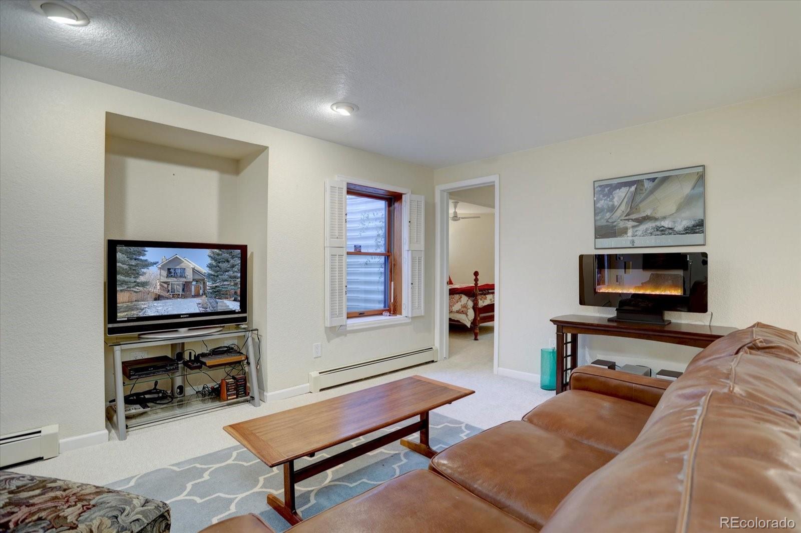 815 16th Street Boulder, CO 80302 - Photo 30 of 47 a living room with furniture and a flat screen tv