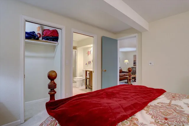 a bed room with a bed and a painting on the wall