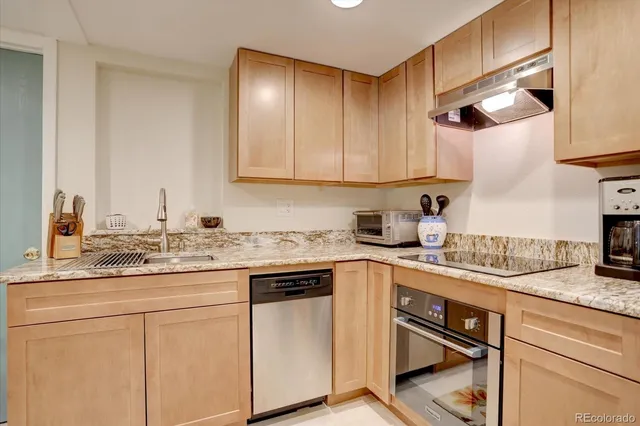 a kitchen with stainless steel appliances granite countertop a sink and cabinets