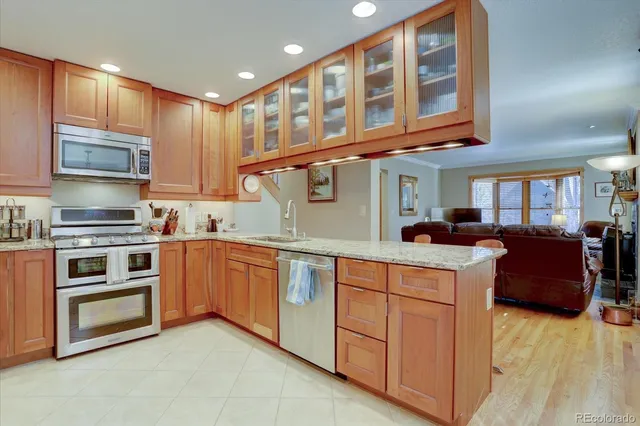 a kitchen with stainless steel appliances granite countertop a stove and a sink