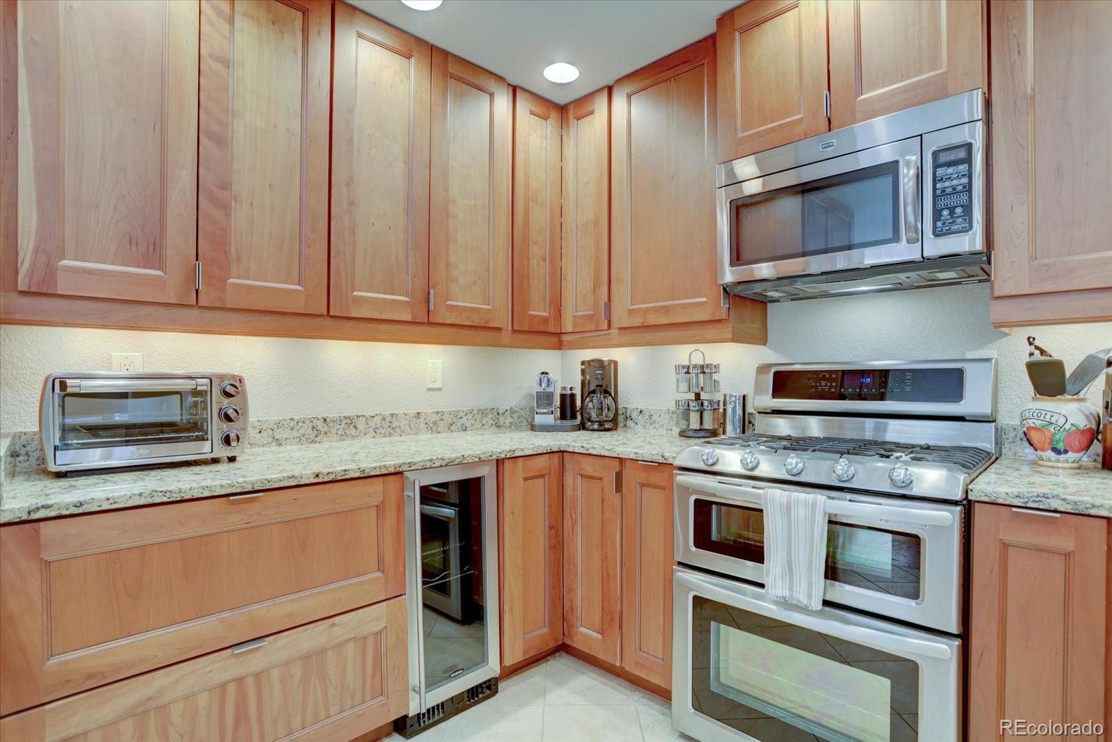 815 16th Street Boulder, CO 80302 - Photo 8 of 47 a kitchen with stainless steel appliances granite countertop a stove microwave and cabinets