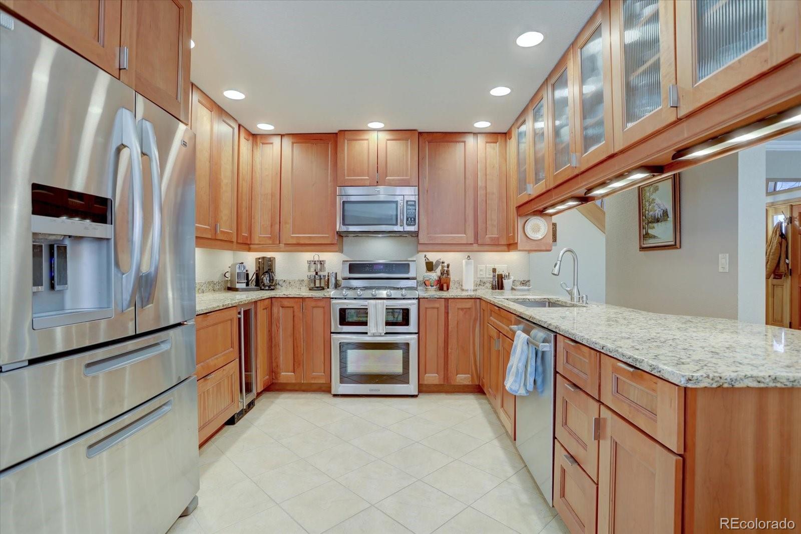 815 16th Street Boulder, CO 80302 - Photo 9 of 47 a kitchen with stainless steel appliances granite countertop a refrigerator sink and cabinets