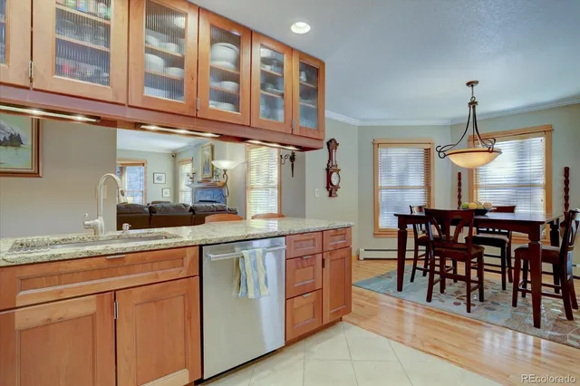 a kitchen with cabinets and chairs