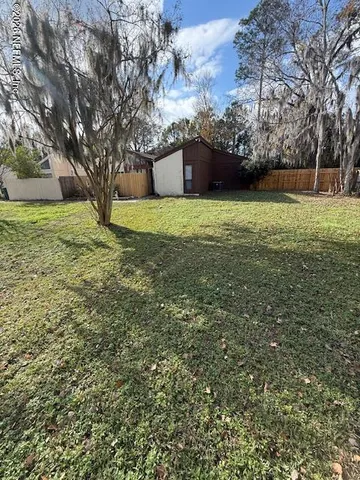 a house view with swimming pool in front of it