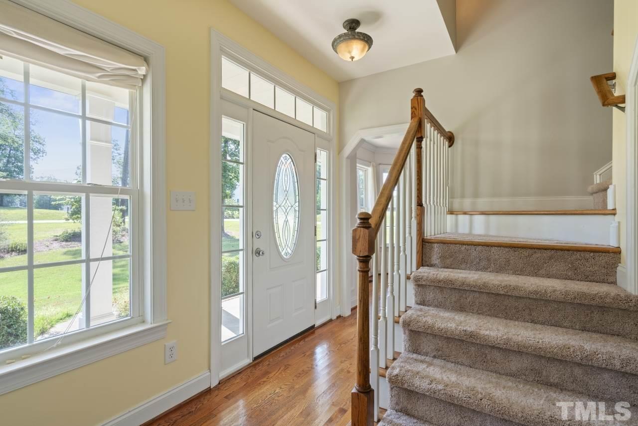 135 Cattle Farm Drive Raleigh, NC 27603 - Photo 2 of 30 a view of staircase with white walls and windows