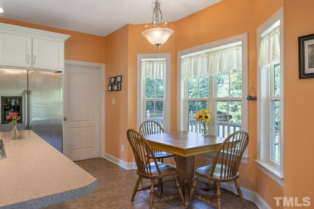 135 Cattle Farm Drive Raleigh, NC 27603 - Photo 11 of 30 a view of a dining room with furniture window and outside view