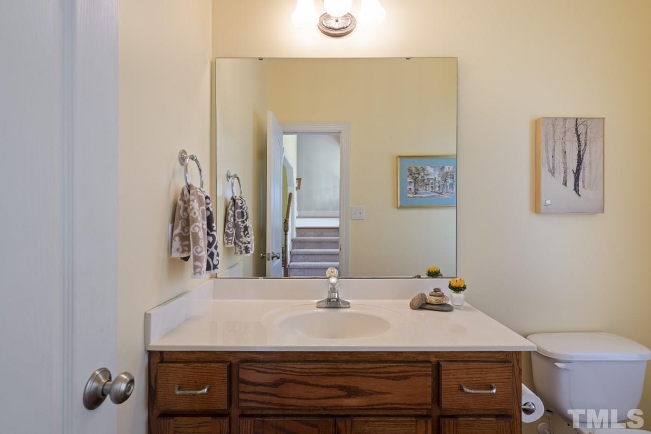 135 Cattle Farm Drive Raleigh, NC 27603 - Photo 13 of 30 a bathroom with a sink and a mirror