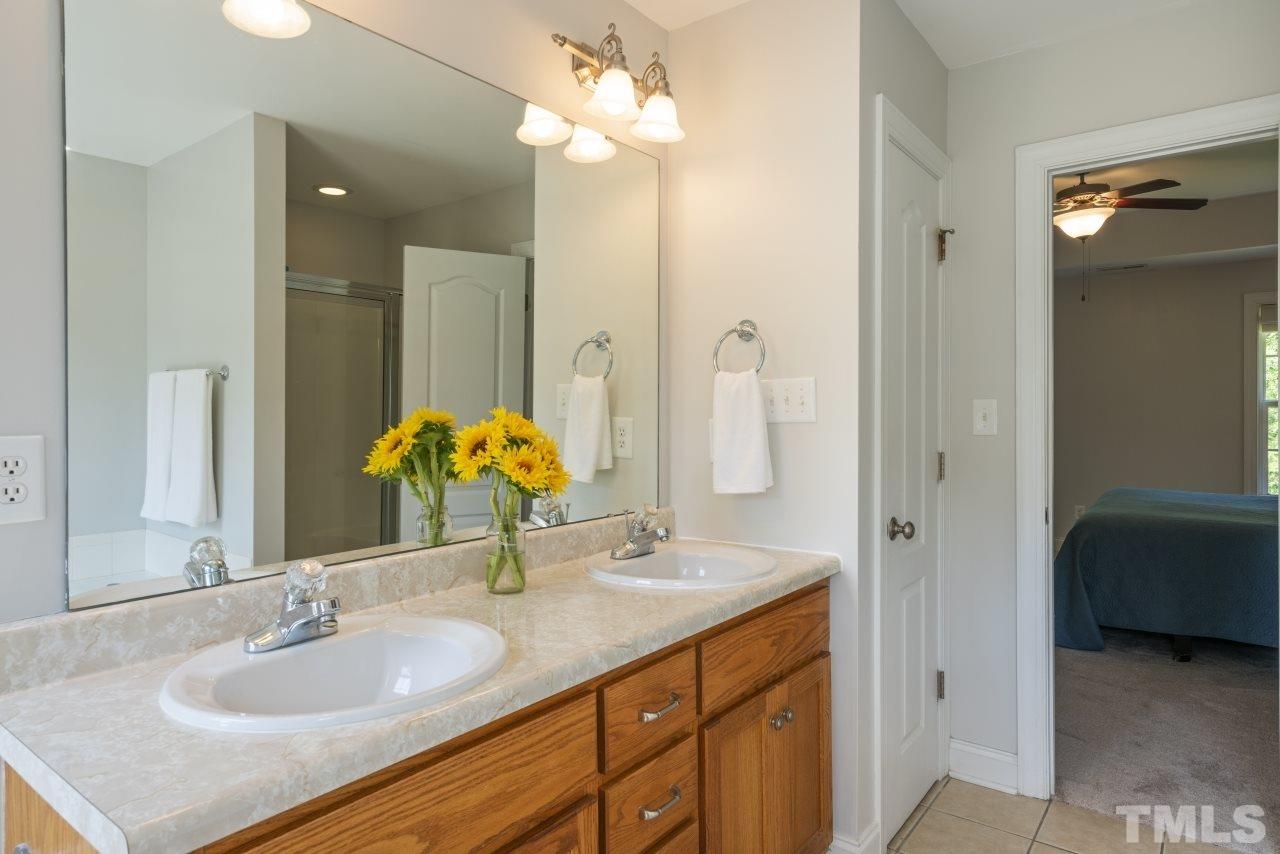 135 Cattle Farm Drive Raleigh, NC 27603 - Photo 17 of 30 a bathroom with a sink double vanity and a mirror