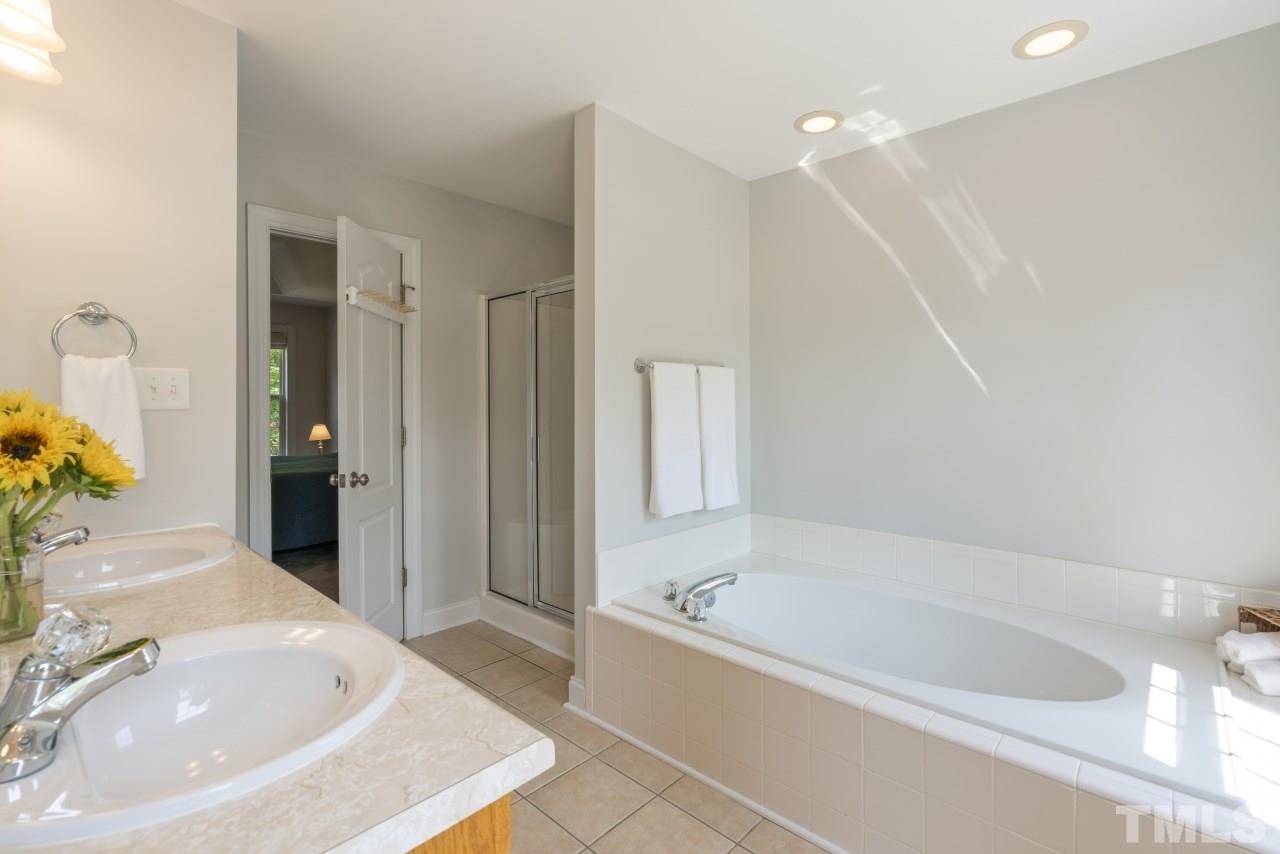 135 Cattle Farm Drive Raleigh, NC 27603 - Photo 18 of 30 a bathroom with a bathtub and a sink