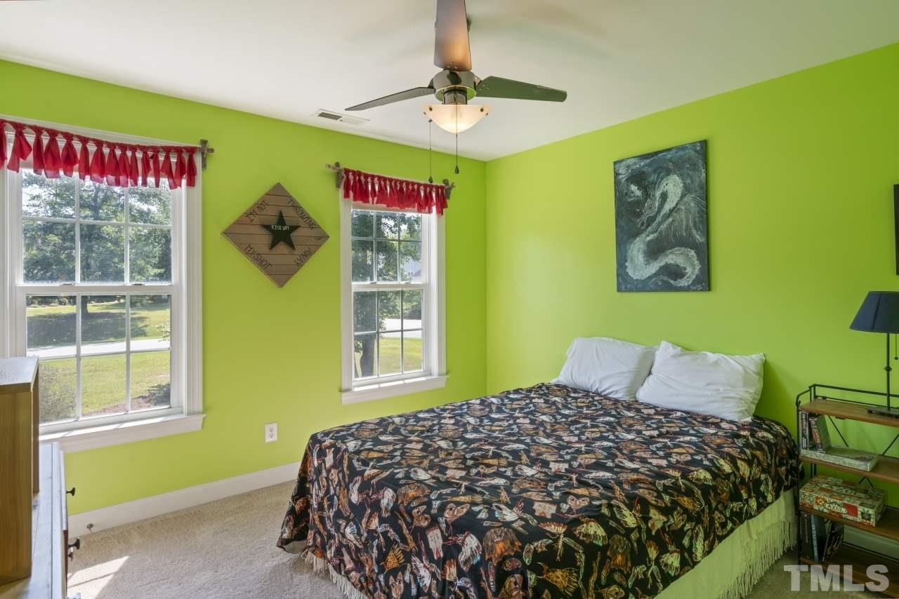 135 Cattle Farm Drive Raleigh, NC 27603 - Photo 19 of 30 a bedroom with a bed and a window