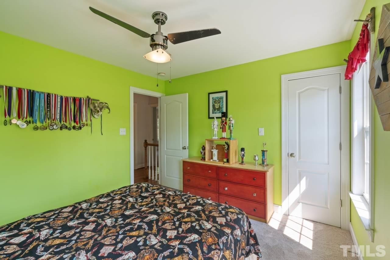 135 Cattle Farm Drive Raleigh, NC 27603 - Photo 20 of 30 a bedroom with a bed and a dresser