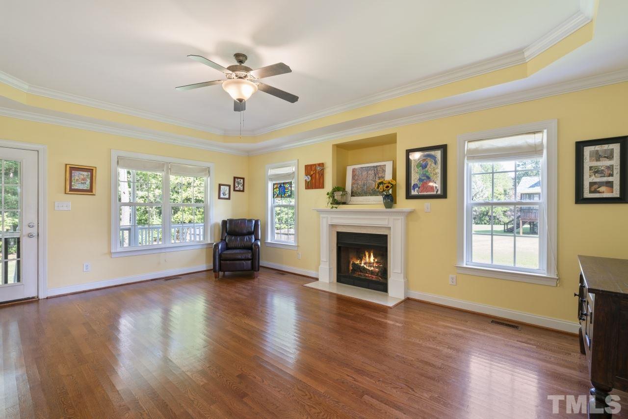135 Cattle Farm Drive Raleigh, NC 27603 - Photo 3 of 30 a view of livingroom with fireplace window and wooden floor