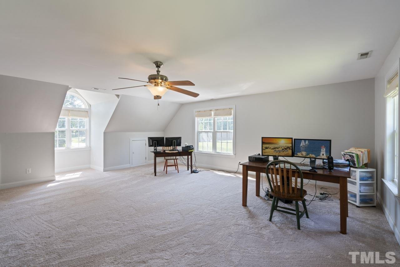 135 Cattle Farm Drive Raleigh, NC 27603 - Photo 24 of 30 a view of a workspace with furniture and a window