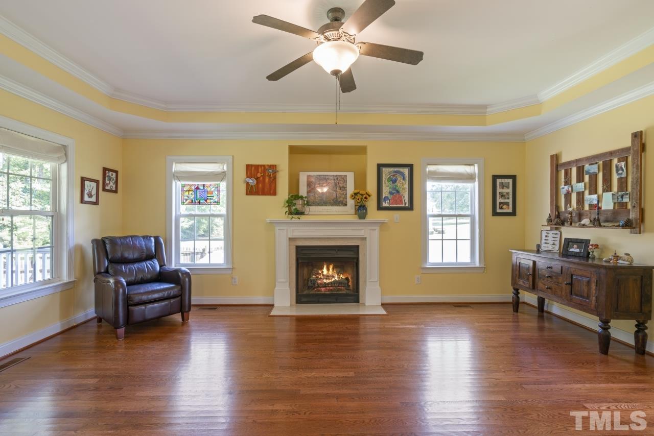 135 Cattle Farm Drive Raleigh, NC 27603 - Photo 4 of 30 a living room with furniture and a fireplace