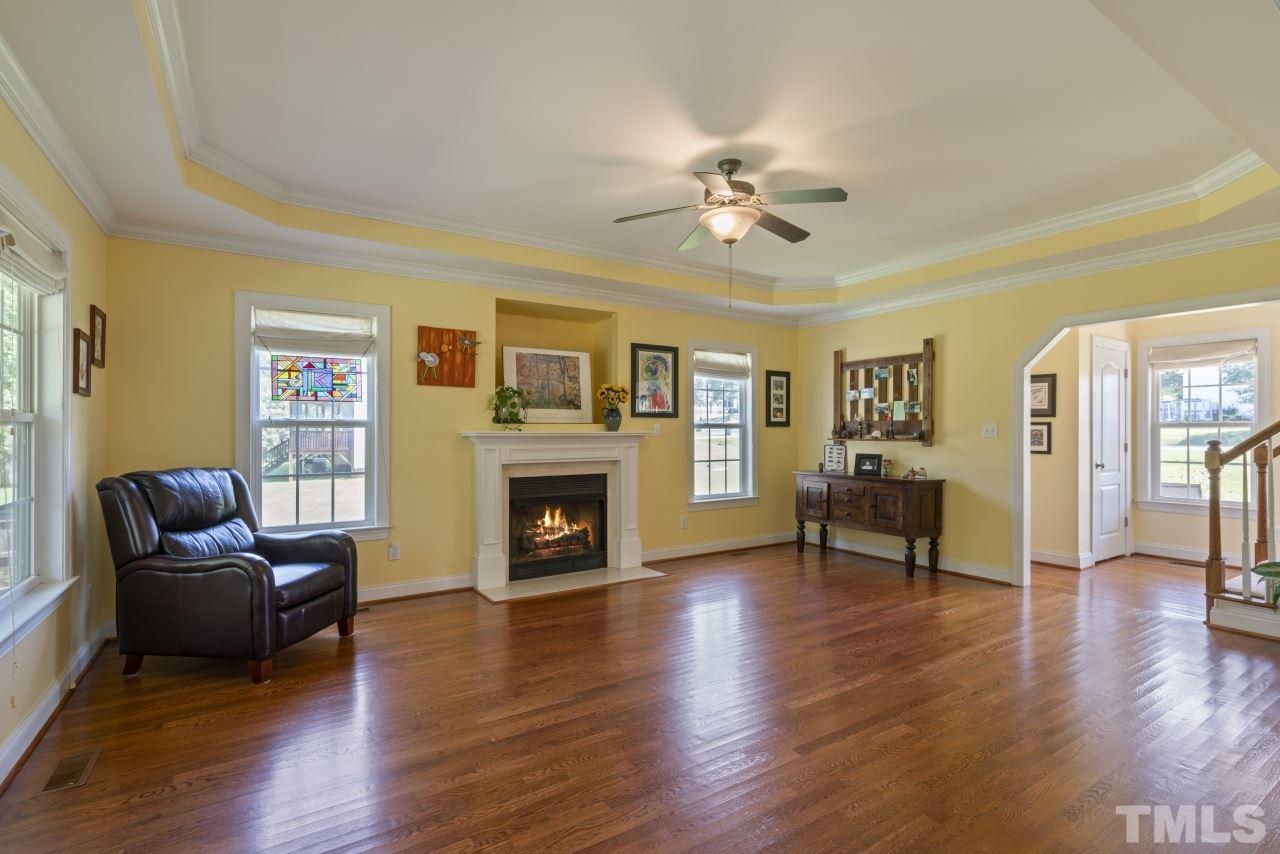 135 Cattle Farm Drive Raleigh, NC 27603 - Photo 5 of 30 a living room with furniture and a fireplace