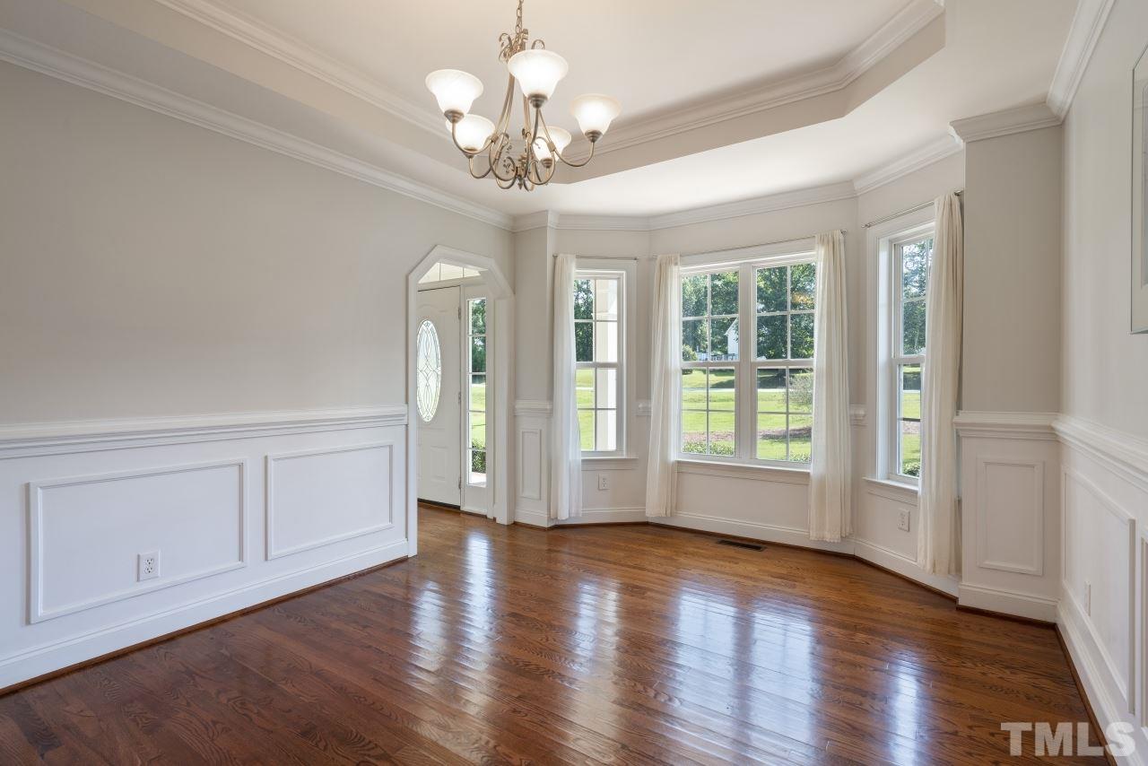 135 Cattle Farm Drive Raleigh, NC 27603 - Photo 8 of 30 a view of an empty room with wooden floor and a window