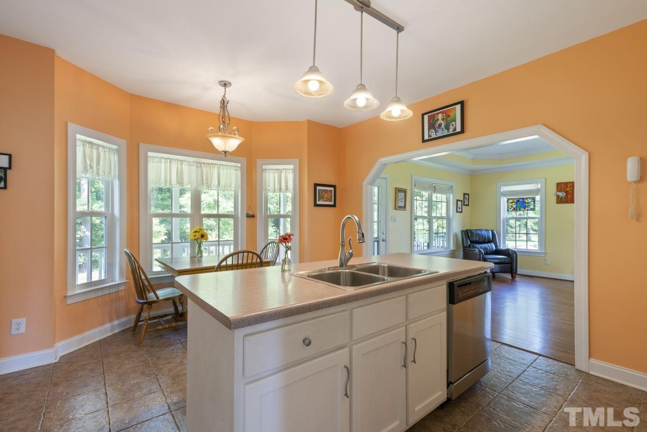 135 Cattle Farm Drive Raleigh, NC 27603 - Photo 10 of 30 a kitchen with a stove and a view of living room